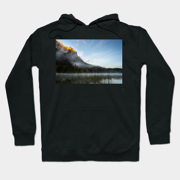 Mist on Alp mountain at Ferchensee. Amazing shot of the Ferchensee lake in Bavaria, Germany, in front of a mountain. Scenic foggy morning scenery at sunrise. Hoodie by EviRadauscher